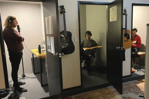NZ Musicians and rangatahi in recording studio booths at Crescendo Studio